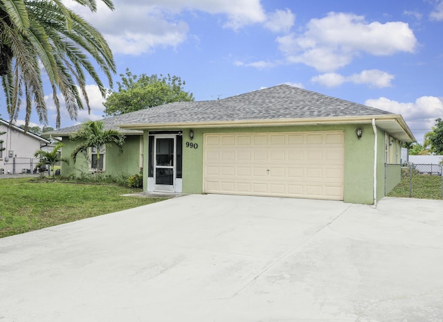 single story home featuring a front lawn and a garage