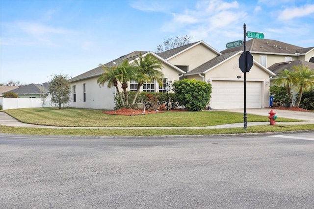 ranch-style home with a front yard and a garage