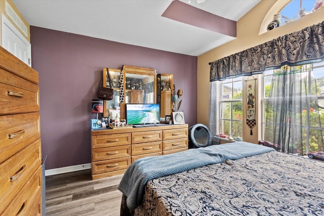 bathroom with a textured ceiling, tile patterned floors, vanity, a bathtub, and vaulted ceiling