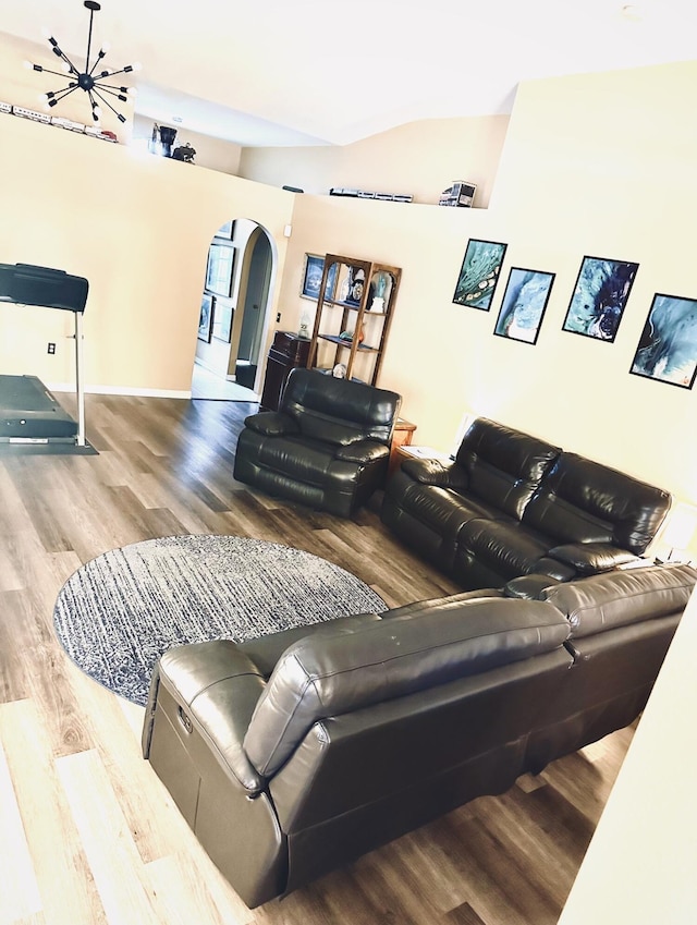 living room with wood-type flooring and an inviting chandelier