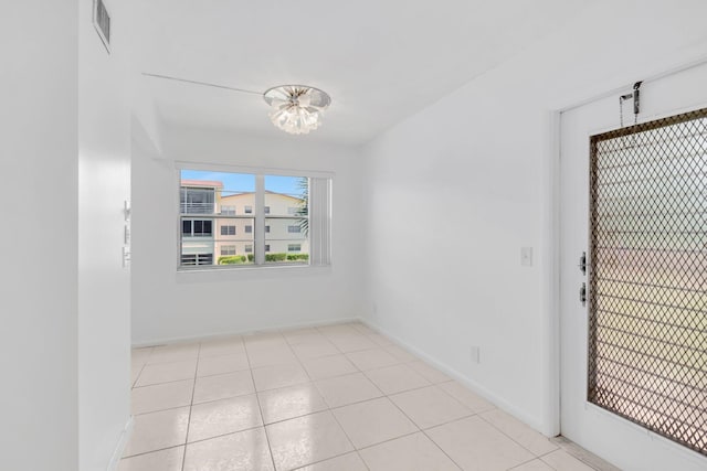 351 Preston I, Boca Raton, FL 33434 - unfurnished room featuring a chandelier, baseboards, and light tile patterned flooring
