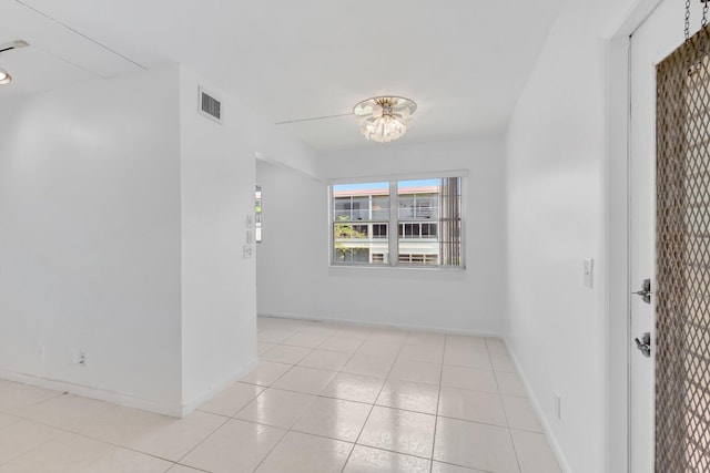 351 Preston I, Boca Raton, FL 33434 - unfurnished room with a chandelier, baseboards, and light tile patterned floors