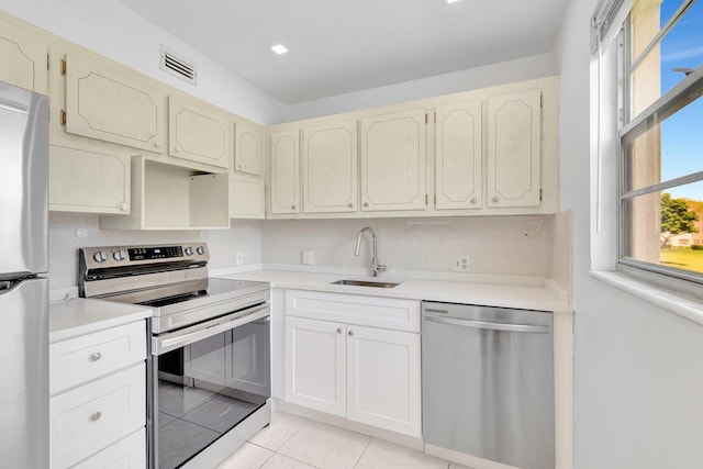 351 Preston I, Boca Raton, FL 33434 - kitchen featuring appliances with stainless steel finishes, a sink, light tile patterned floors, and light countertops