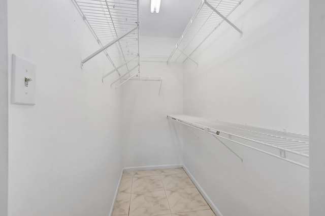 351 Preston I, Boca Raton, FL 33434 - walk in closet featuring light marble finish floors