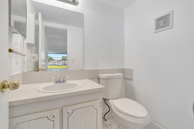 351 Preston I, Boca Raton, FL 33434 - half bathroom featuring toilet, vanity, and baseboards