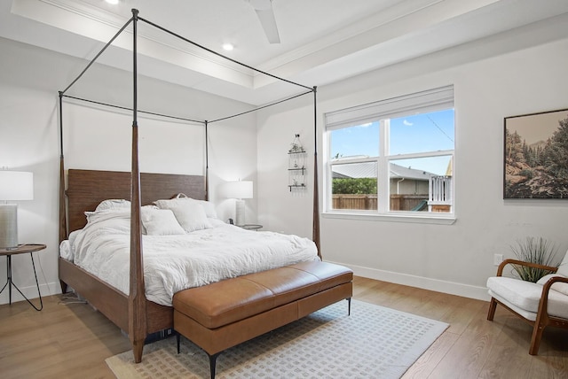 bedroom featuring ceiling fan, ornamental molding, and hardwood / wood-style floors