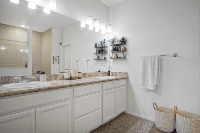 bathroom featuring vanity and a tile shower