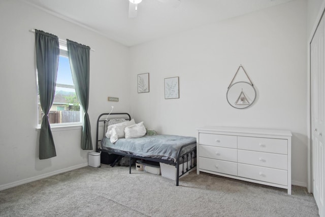 bedroom featuring ceiling fan, light colored carpet, and a closet