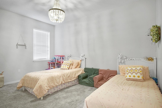 bedroom with an inviting chandelier and carpet floors