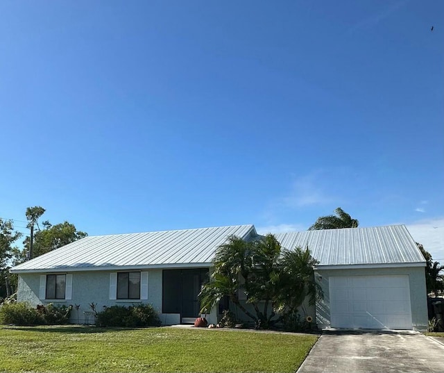 ranch-style home with a garage and a front lawn