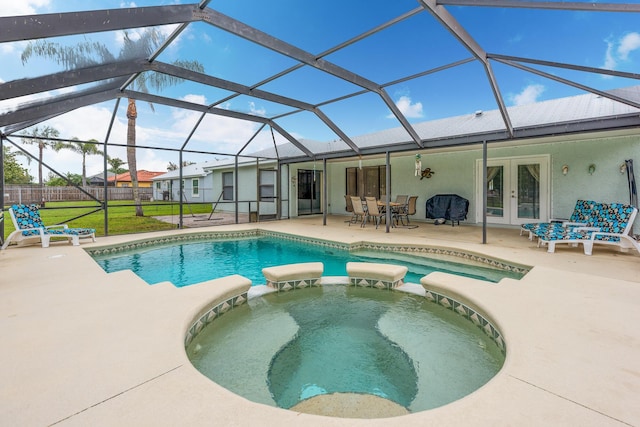 view of swimming pool featuring glass enclosure, an in ground hot tub, french doors, and a patio