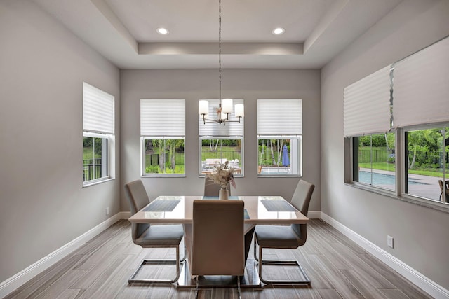 dining room featuring a chandelier and a tray ceiling