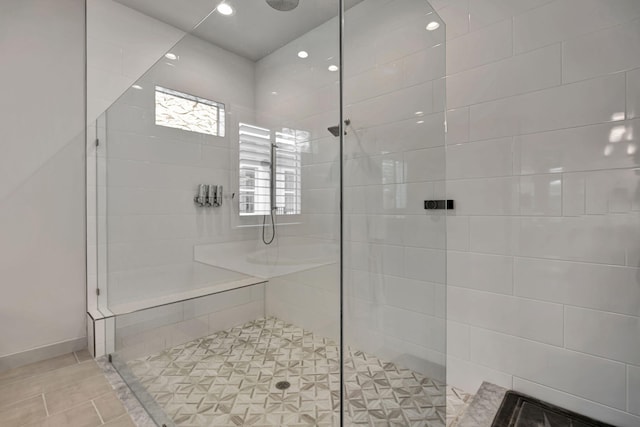 bathroom with a tile shower