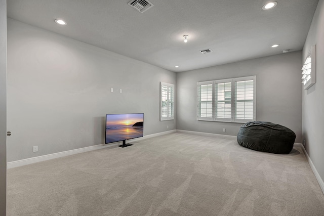 unfurnished room featuring light carpet