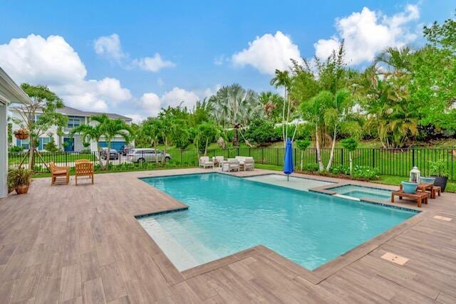 view of swimming pool with an in ground hot tub, outdoor lounge area, and a patio