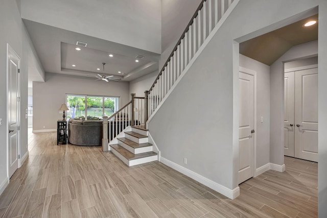 staircase featuring ceiling fan