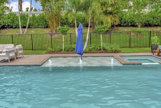 view of pool with pool water feature, an in ground hot tub, and a lawn