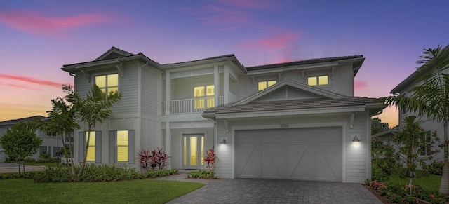 view of front of home featuring a balcony and a lawn