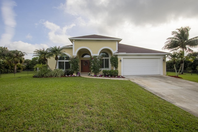 view of front of home featuring a garage and a front yard