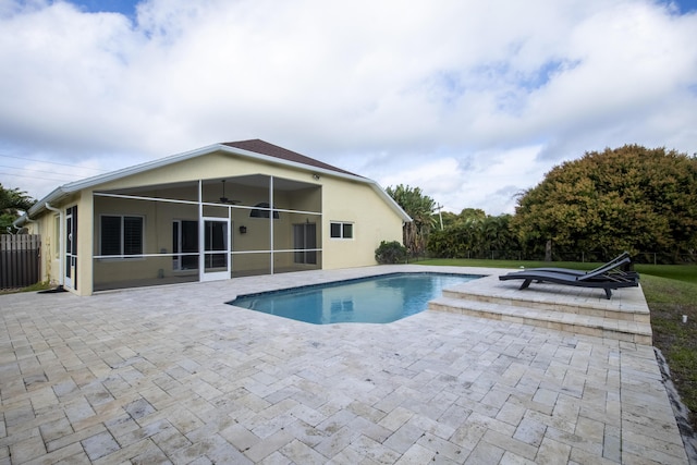 outdoor pool with a ceiling fan, a sunroom, a patio area, and fence