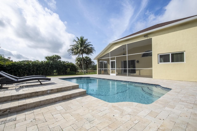 outdoor pool featuring a patio area and a sunroom