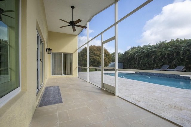 outdoor pool with a lanai, a patio, and ceiling fan