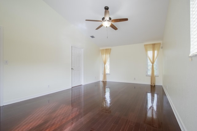 unfurnished room featuring baseboards, visible vents, a ceiling fan, lofted ceiling, and wood finished floors