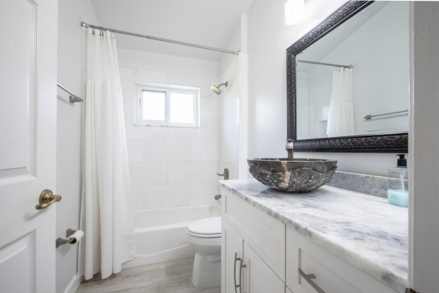 full bathroom with wood finished floors, vanity, toilet, and shower / tub combo