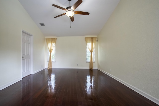 spare room featuring vaulted ceiling, dark hardwood / wood-style floors, and ceiling fan