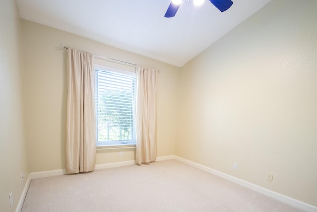 unfurnished room with lofted ceiling, light colored carpet, ceiling fan, and baseboards