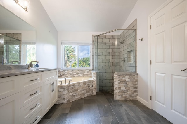 bathroom featuring lofted ceiling, wood-type flooring, separate shower and tub, and vanity