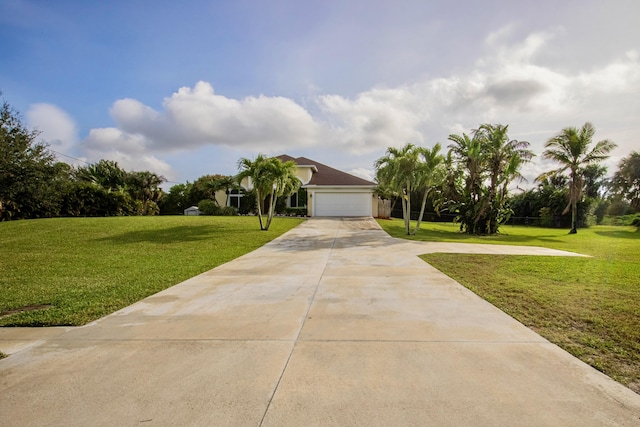 obstructed view of property featuring a garage and a front lawn