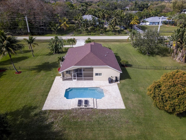 view of pool featuring a patio, a sunroom, and a yard