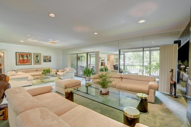 carpeted living room featuring a wall of windows