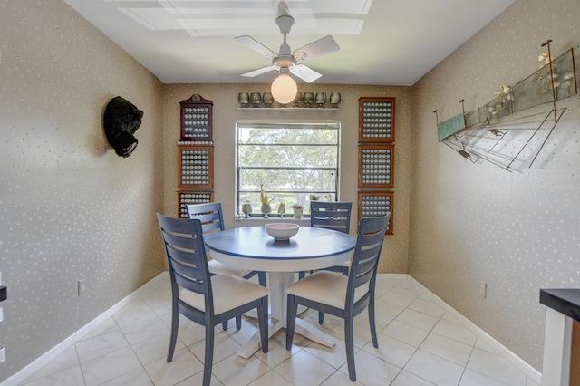 tiled dining area with ceiling fan