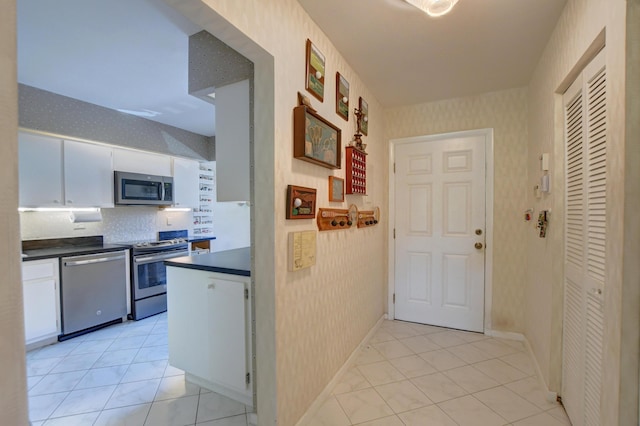 hall featuring light tile patterned flooring