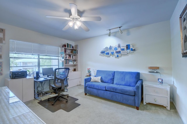 office with ceiling fan, light colored carpet, and rail lighting