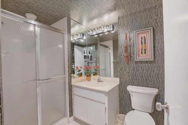 bathroom featuring walk in shower, vanity, tile patterned floors, and toilet