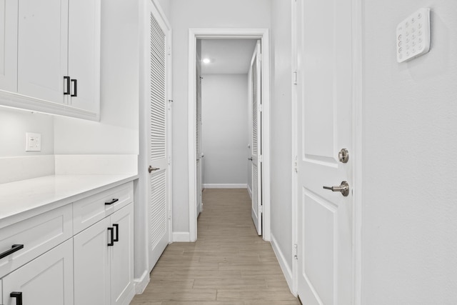 corridor with light hardwood / wood-style flooring