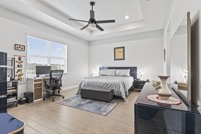 bedroom featuring ceiling fan and a tray ceiling