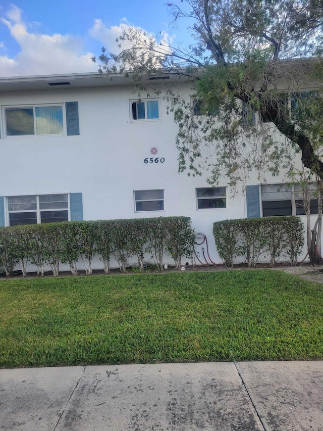 view of side of home featuring a lawn