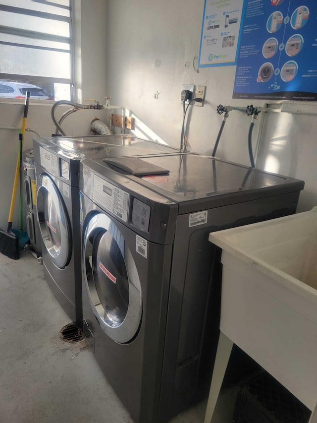 laundry area featuring sink and washing machine and clothes dryer