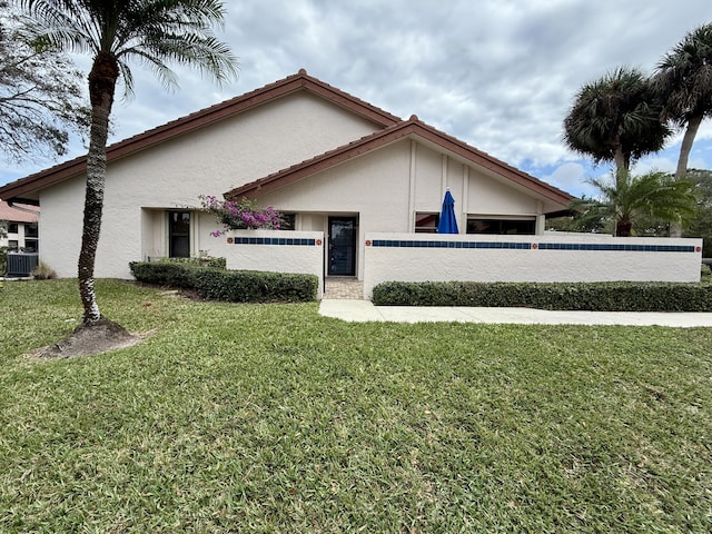 view of property exterior featuring central AC and a lawn