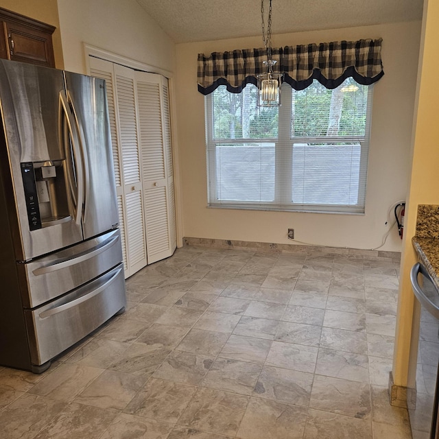 kitchen featuring lofted ceiling, hanging light fixtures, dark brown cabinets, stone countertops, and stainless steel fridge with ice dispenser