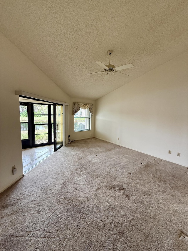 unfurnished room featuring high vaulted ceiling, light carpet, a textured ceiling, and ceiling fan