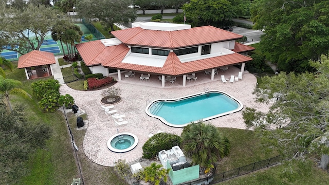 view of swimming pool featuring a hot tub, a patio, and an outdoor fire pit