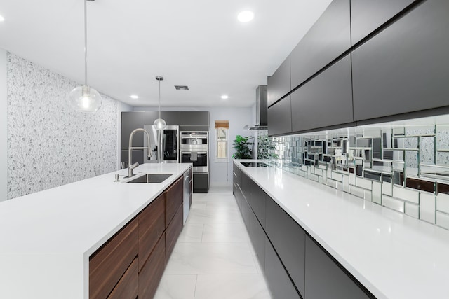 kitchen featuring exhaust hood, stainless steel double oven, decorative backsplash, black electric cooktop, and decorative light fixtures