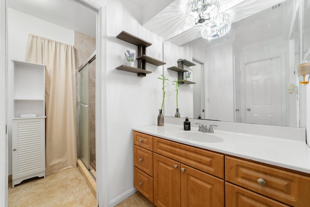 bathroom featuring tile patterned floors, an enclosed shower, and vanity