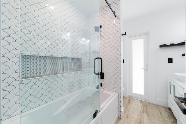 bathroom with wood-type flooring and tiled shower / bath combo