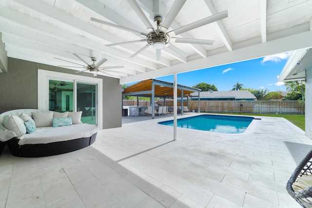 view of swimming pool with ceiling fan, outdoor lounge area, and a patio